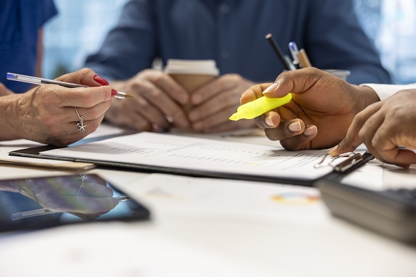 financial advisor expert highlighting terms on retirement plan contract